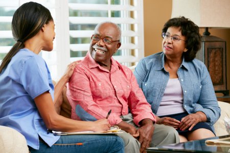 therapist discussing sleep management with elderly couple